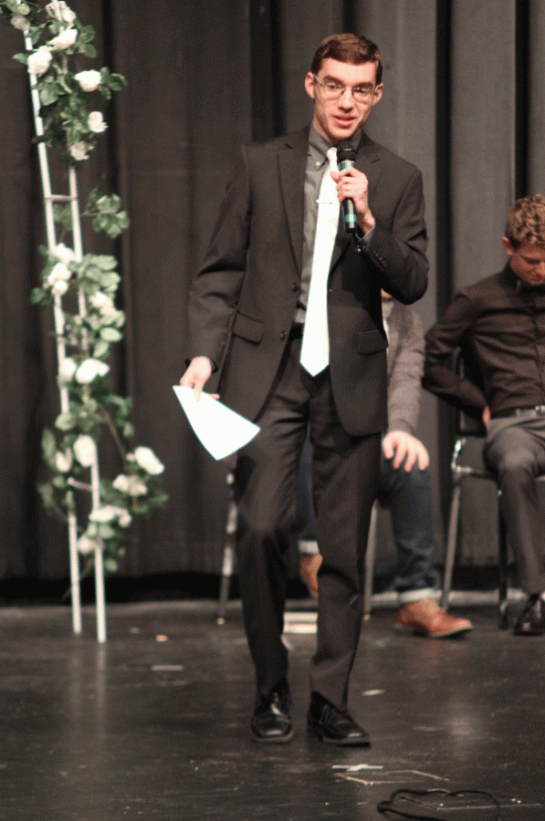 Junior Tom McClain looks at the crowd as he reads his poetry piece.