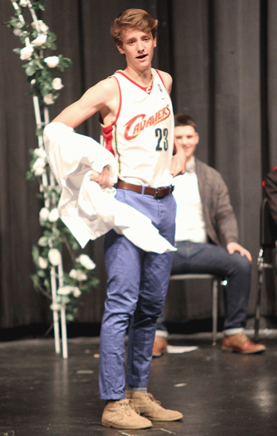 Junior Spencer Butterfield shows his jersey as he recites poetry.