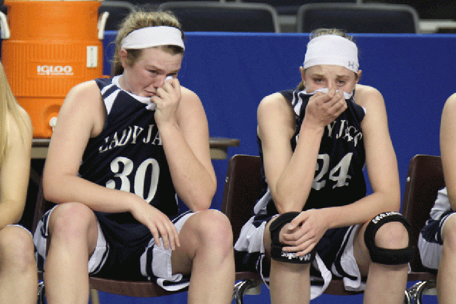Senior Catie Kaifes and sophomore Evan Zars sit on the bench in the last few minutes of the game.