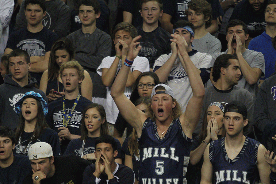 Waving his arms in the air, senior Lucas Krull yells during a free throw.