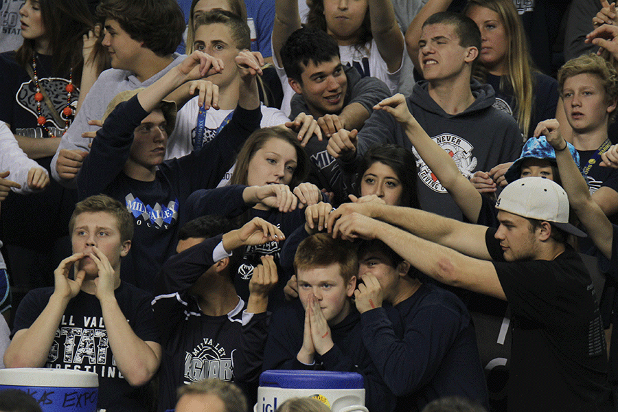 The student section rubs senior Cameron Thompsons head for good luck.