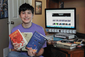 While at his desk, sophomore Graham Wilhauk displays his favorite books discussed on his personal youtube channel on Saturday, Feb. 27.