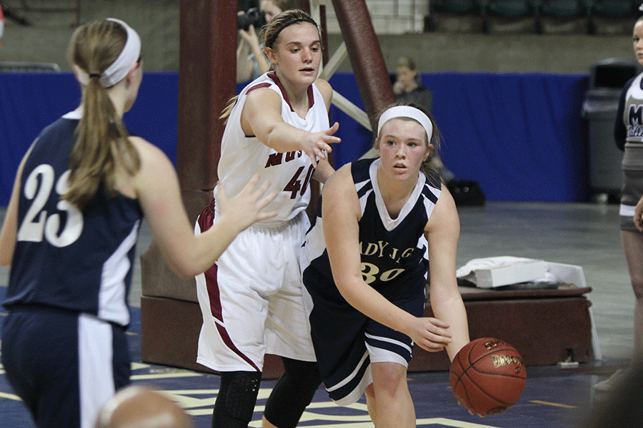 With the defense approaching, senior Catie Kaifes looks to pass to freshman Claire Kaifes.