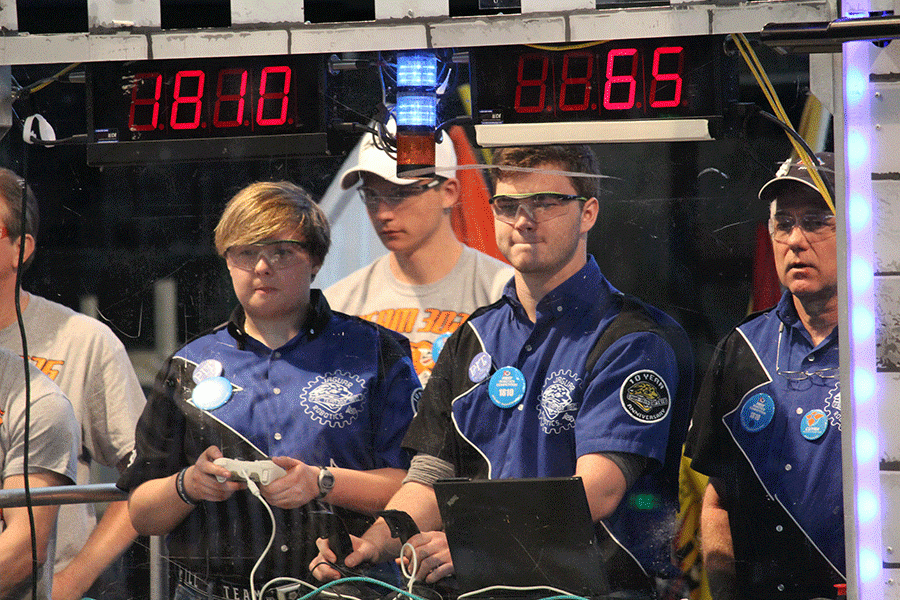 Senior Sarah Soriano and DeSoto senior Rhett Pierce control the teams robot from the pit during one of the matches at the Iowa regional competition. 