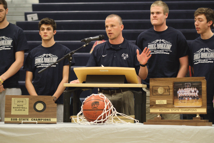 Varsity boys basketball coach Mike Bennett thanks the students for attending the games and being supportive of the team at the state basketball pep rally on Tuesday, March 22.