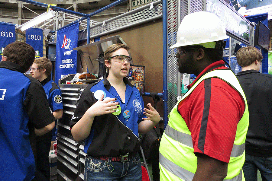 Junior Taylor Barth discusses team safety procedures at the Iowa regional competition with a safety advisor.