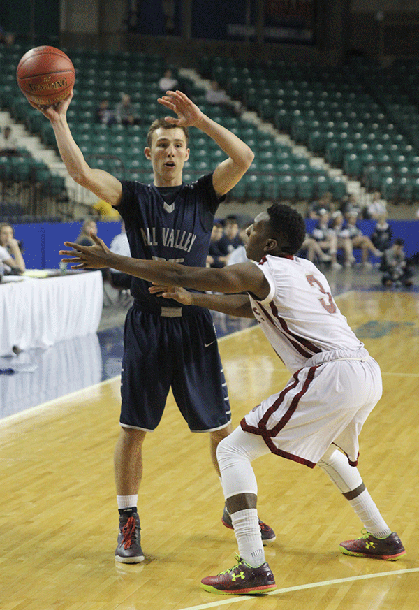 Senior Jaison Widmer holds the ball away from his opponent.