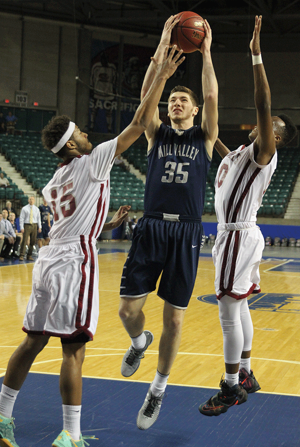 Senior Clayton Holmberg looks past his opponents and towards the basket.