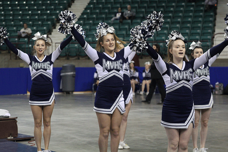 As the fight song plays to wrap up the first half, members of the cheer team cheer.