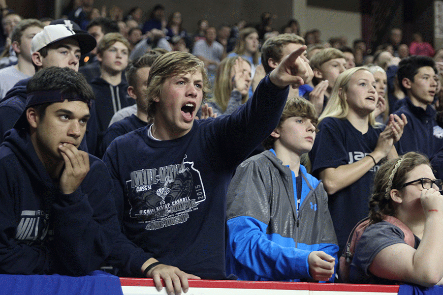 Sophomore Evan Rice cheers after the Jaguars score.