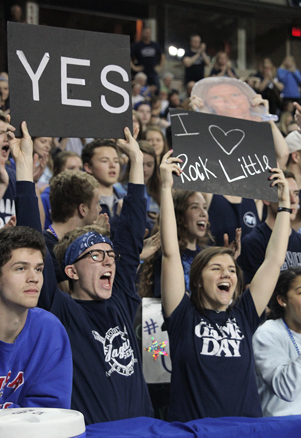 Seniors Shane Calkins and Val Merriman hold up signs.