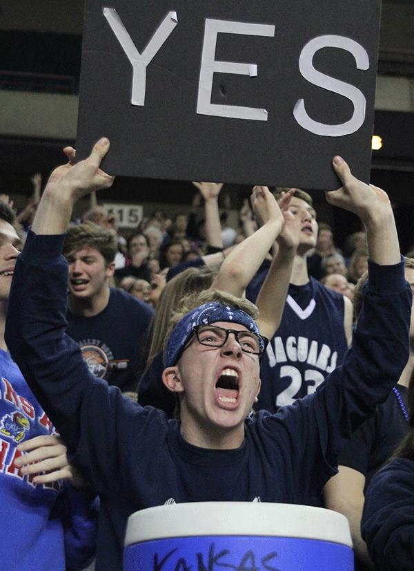 Senior Shane Calkins holds up a sign after the Jaguars secure a win.