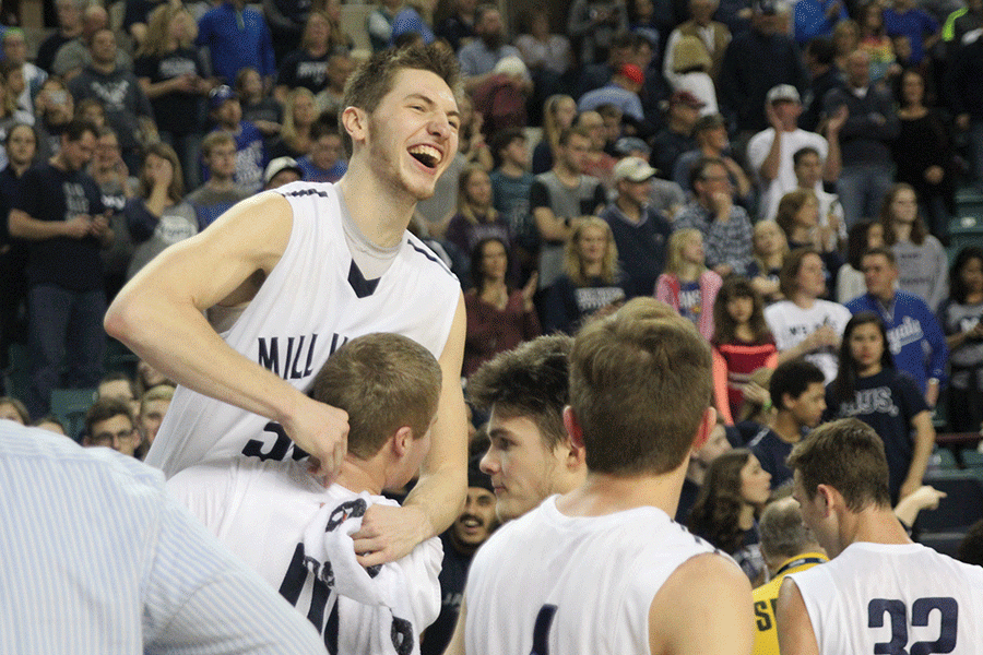 Senior Tyler Grauer holds up senior Clayton Holmberg after the Jaguar win.