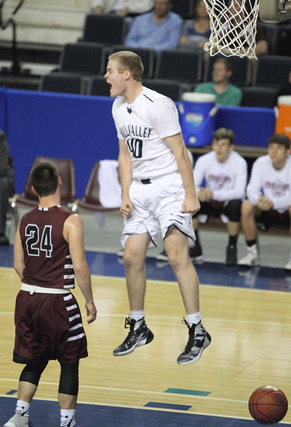 After senior Jaison Widmer makes a basket as the buzzer to end first quarter sounds, senior Tyler Graurer jumps in excitement. 