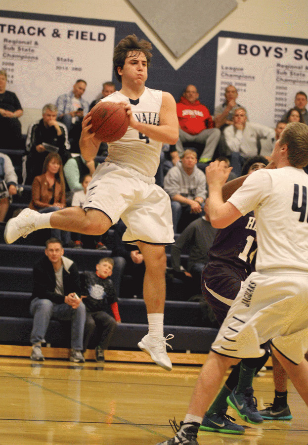 Senior Logan Koch jumps in the air to pass the ball.