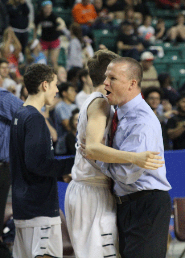 Head coach Mike Bennett hugs senior Ethan Lane at the conclusion of the game.