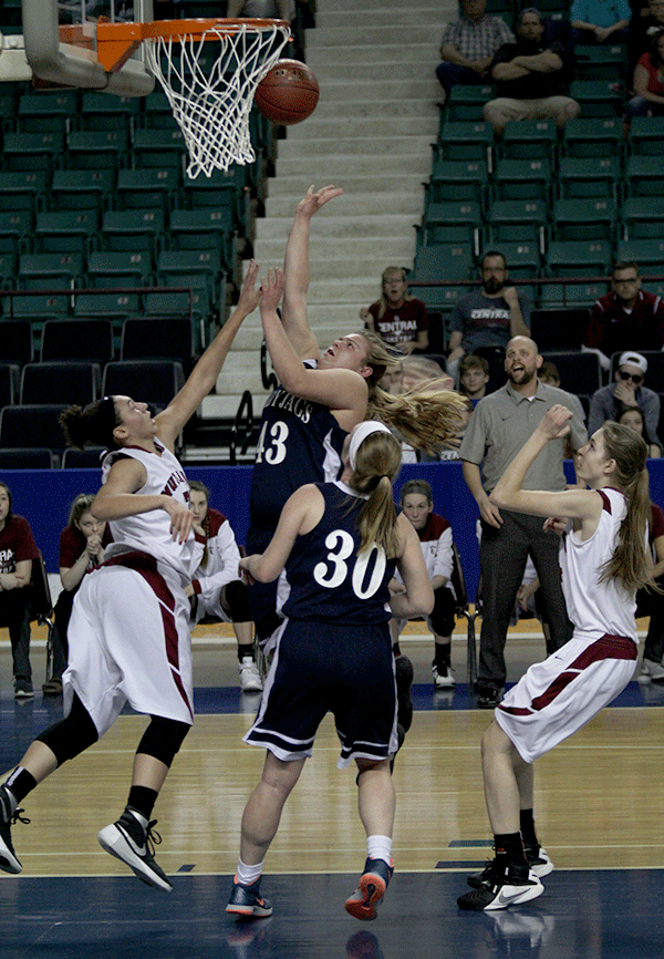 Surrounded by Salina Central opponents, junior Ashlyn Hendrix attempts to shoot.