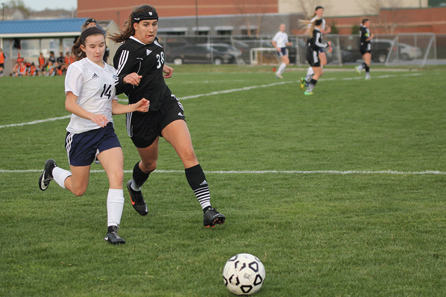 Senior forward Kennedy Hoffman fends off the opponent. 