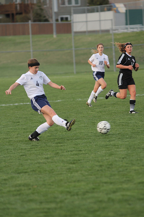 Senior midfielder Emma Wetzel passes the ball to teammate. 
