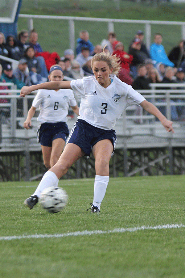 Junior forward Sydney Hookstra kicks the ball. 