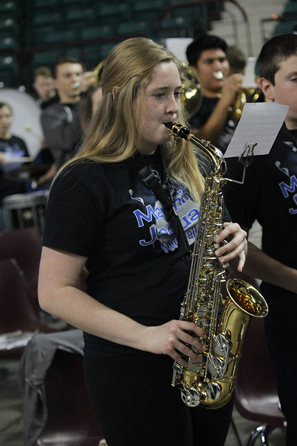 Senior Isabel Crain plays her saxophone during the game. 