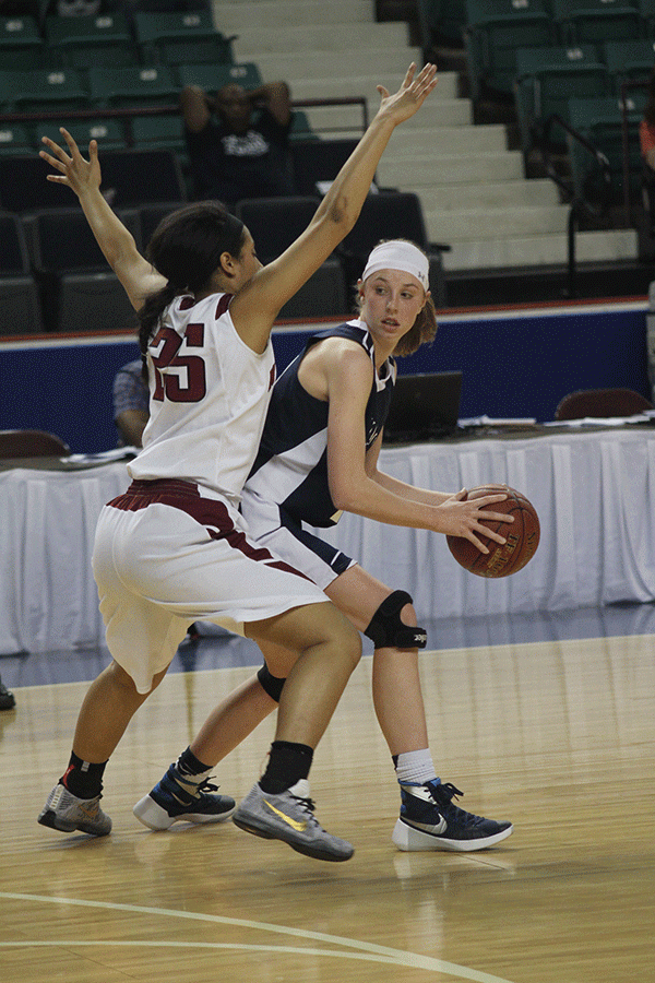 Sophomore Evan Zars tries to turn around to pass the ball. 