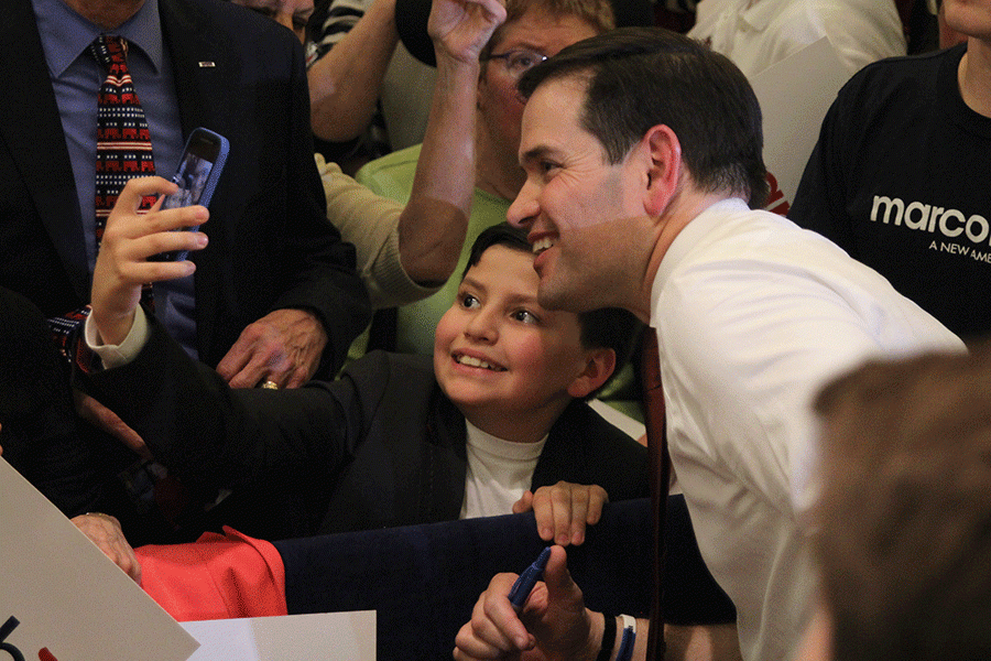 While meeting supporters and spectators after the rally, Rubio smiles while a young supporter takes a selfie with him.