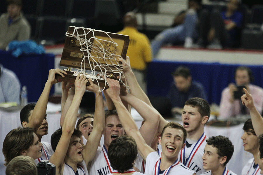 With the state trophy in their hands, the basketball team celebrates their win.