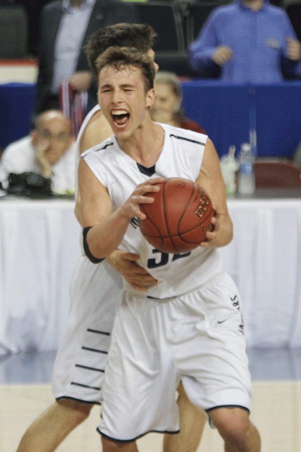 Senior Jason Widmer holds the game ball after winning.