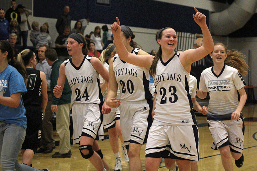 With her hands in the air, freshman Claire Kaifes looks to the crowd to celebrate the Lady Jags win against Blue Valley Southwest on Saturday, March 5.