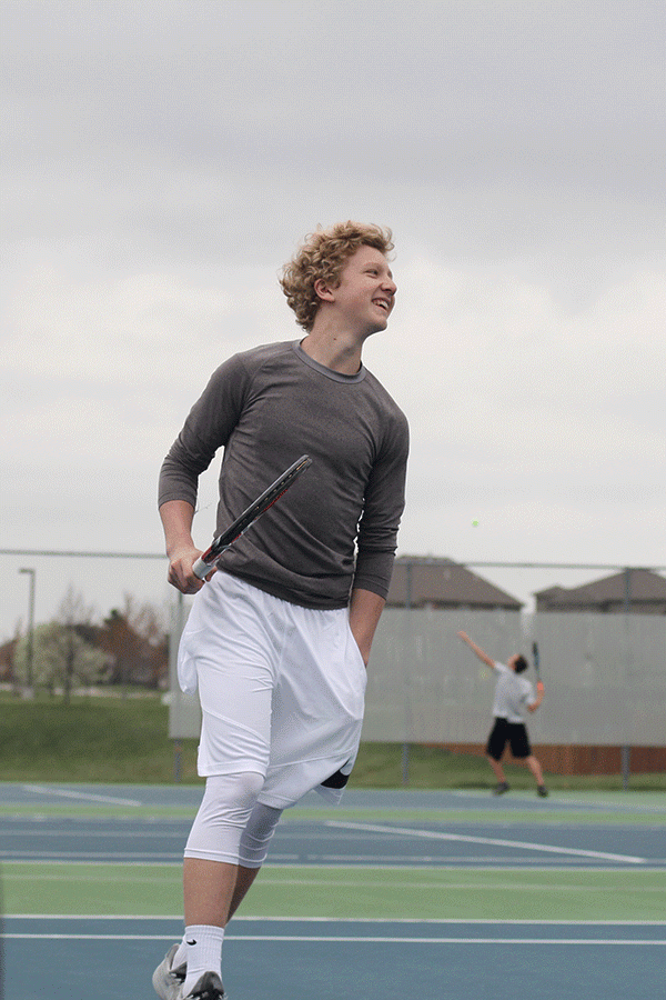 Sophomore Dante Peterson celebrates advancing his score during a doubles match. 