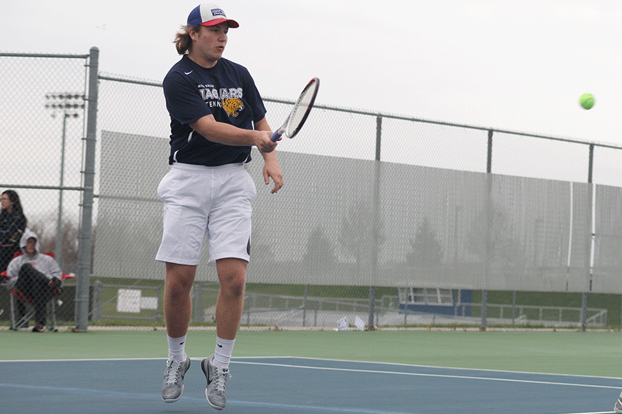 Senior Tyler Shurley hits the ball after being served by his opponent. 