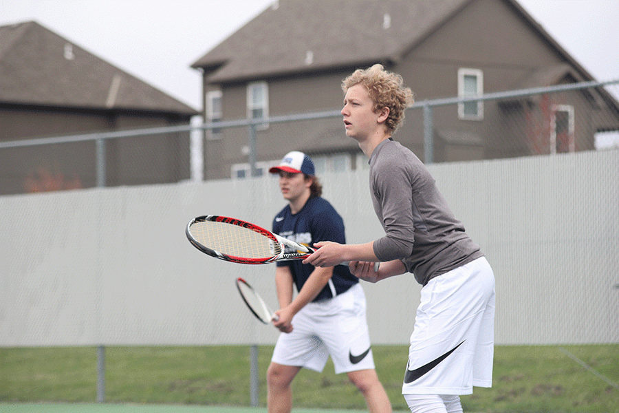 Sophomore Dante Peterson and his doubles partner senior Tyler Shurley wait for the ball to come across the net.