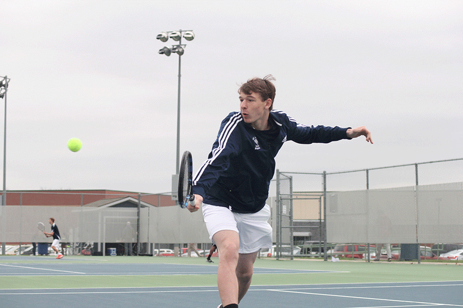 Junior Alec Bergeron reaches to hit the ball. 