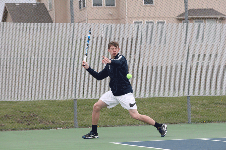 Running towards the ball, junior Alec Bergeron begins to swing. 