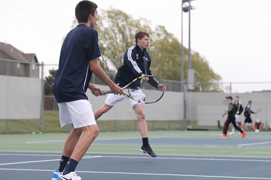 Junior James Bock focuses as his parter swings at the ball