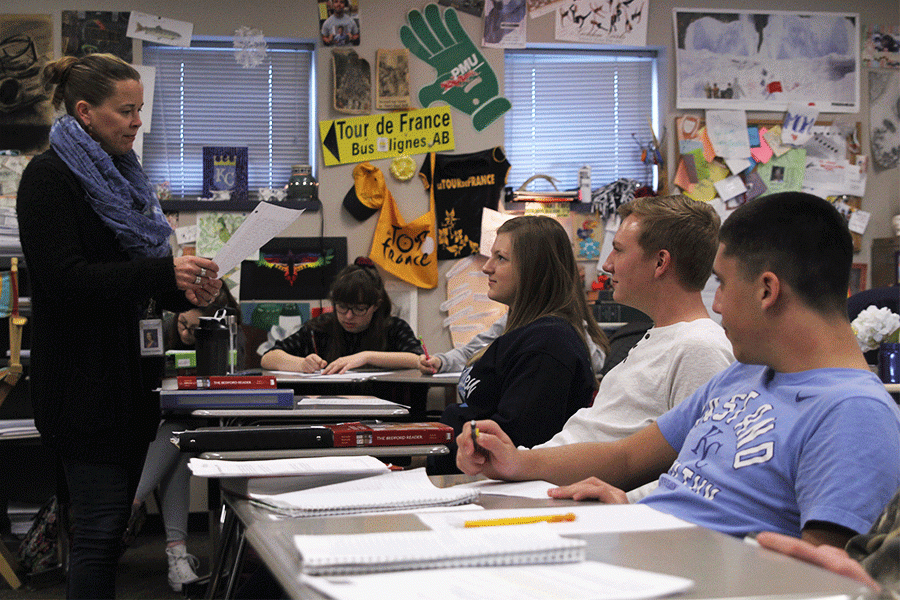 In AP Language and Composition, juniors Jazz Loffredo, Brady Rolig and Payton Frye (pictured right to left) wait patiently while communication arts teacher Kristen Crosbie checks their homework on Friday, Feb. 26.