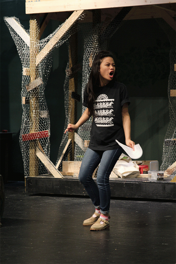 Portraying her role of Puck, senior Camille Gatapia yells across stage to her castmates playing fairies during a scene at rehearsal on Thirsday, March 31.