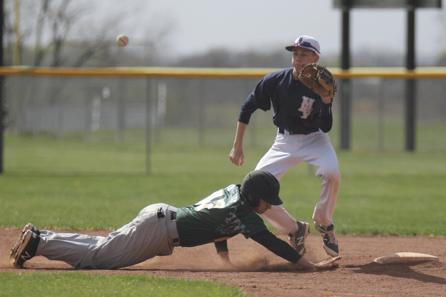 Senior Tanner Reed catches a throw to get the Bobcat runner out.