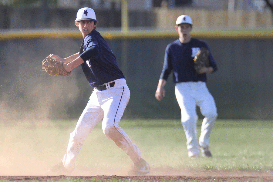 After fielding a ball, sophomore Baylen Kelley prepares to throw out another player.