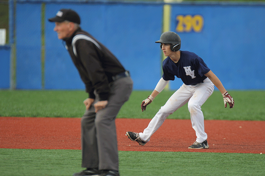 Sophomore Gage Miller watches before stealing third base.