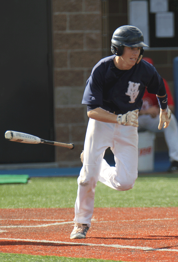 Senior Tanner Reed takes off from home plate after hitting a pop fly.