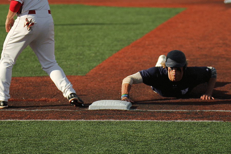 Senior outfielder Lucas Krull slides back to first base after leading off.
