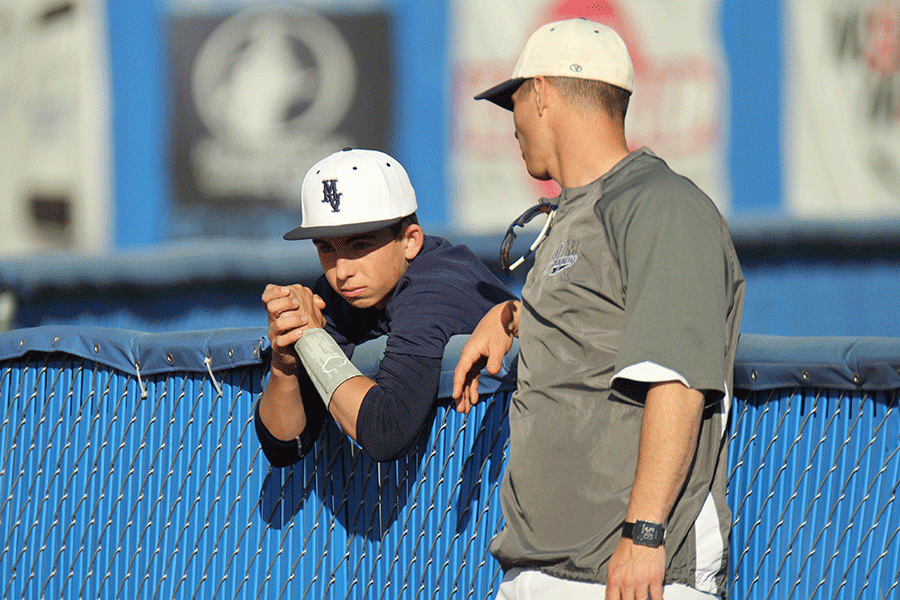 Assistant coach Dustin Stinett talks to one of his players during the game.