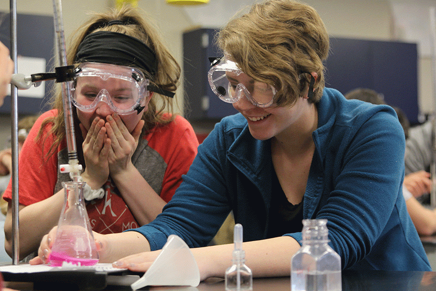 Hands covering her mouth in disbelief, junior Hannah Friesen reacts to pouring too much solution into an Erlenmeyer Flask for her titration chemical experiment making it a bright pink color on Thursday, April 21. “I like how we were in control of the experiment and how we got to see the reaction ourselves,” Friesen said. “I was a bit disappointed with the result, but overall I was still excited with the color.”