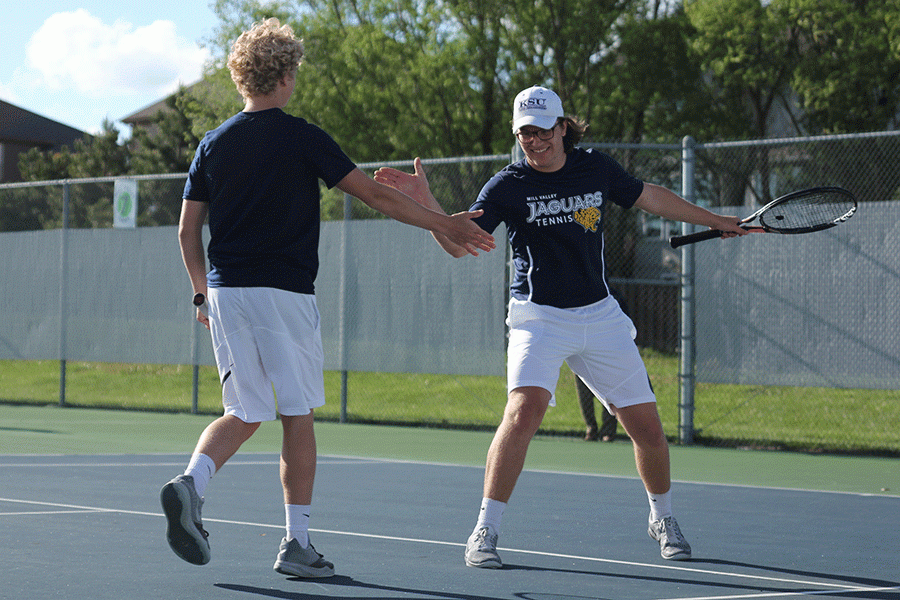 After their opposing team is unable to hit the ball back to them, senior Tyler Shurley and sophomore Dante Peterson high five.