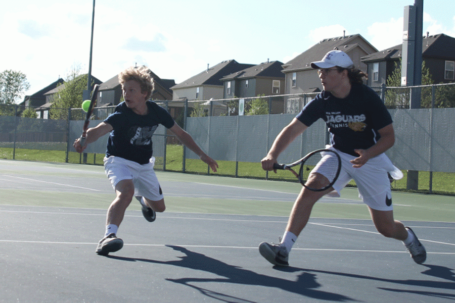 Doubles teammates senior Tyler Shurley and sophomore Dante Peterson rush to the ball.