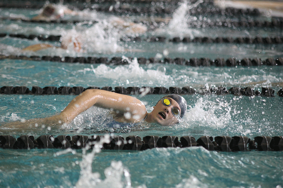 Nearing the finish, junior Emma Dandridge swims in the 100 yard freestyle.
