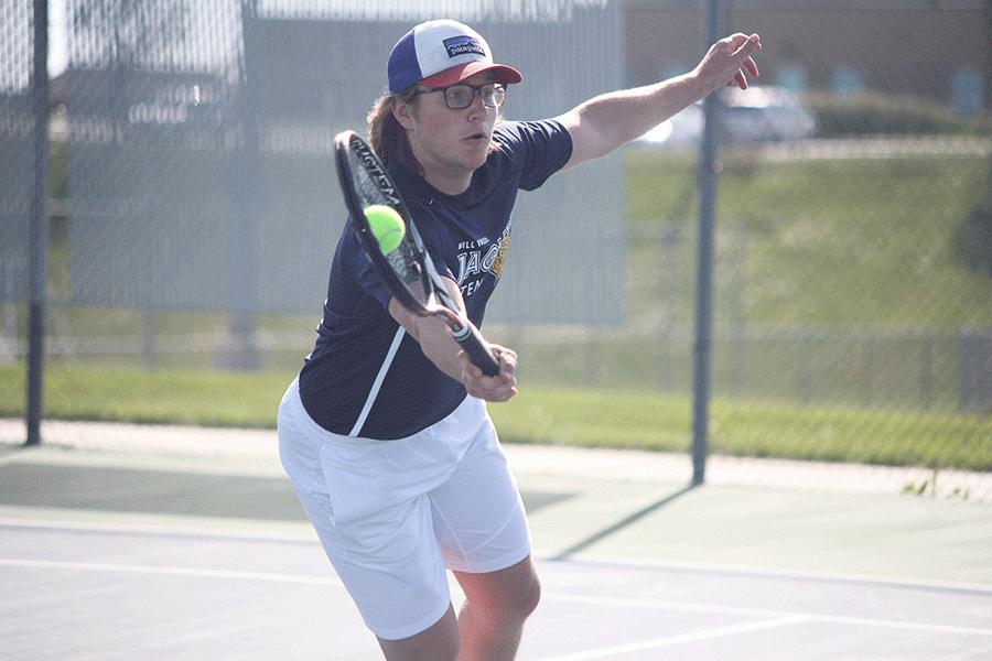Senior Tyler Shurley focuses on the game as the ball meets his racket. 