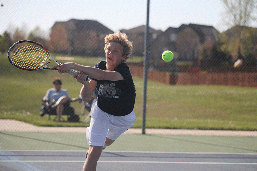 Sophomore Dante Peterson hits the ball during a doubles match